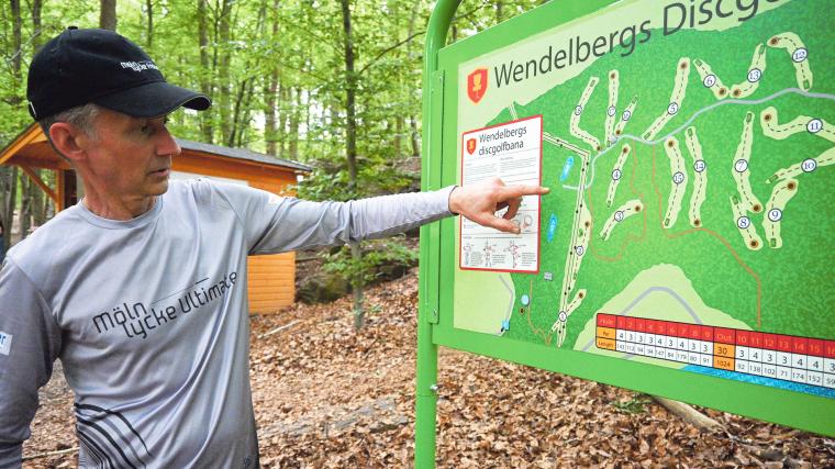 Mölnlycke Frisbee Clubs ordförande Daniel Frosterud demonstrerar kartan över nya 18-hålsbanan.