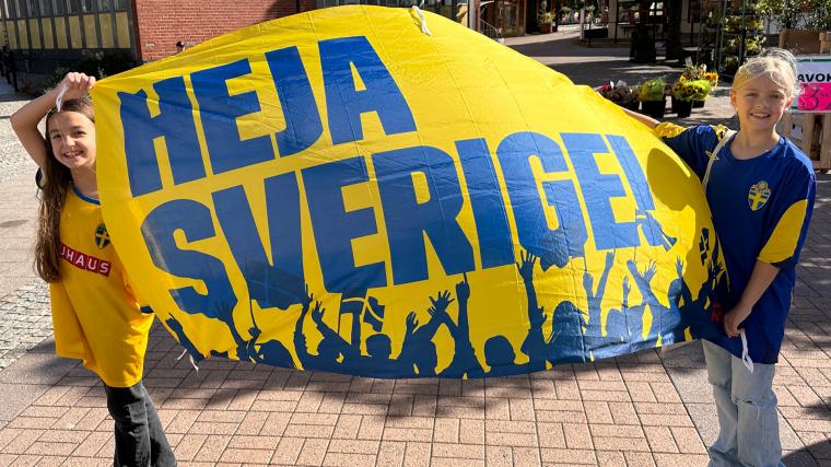 Heja Sverige friskt humör. Julia och Hilda hade tagit med sig en finfin banderoll.